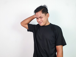 A cheerful young Asian man wearing a black shirt poses confidently against a plain, white background. He appears relaxed and happy, showcasing a natural and confident demeanor.