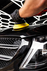 Car hood being polished with yellow pad. Paint polishing in active motion. Paint polishing to...