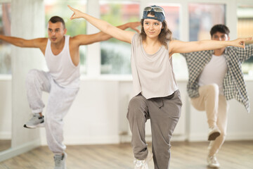 Group of young hip-hop dancers rehearsing in the studio. Dancers full of energy