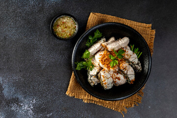 steamed sea bass sliced fish with dipping sauce and vegetable