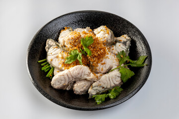 steamed sea bass sliced fish with dipping sauce and vegetable