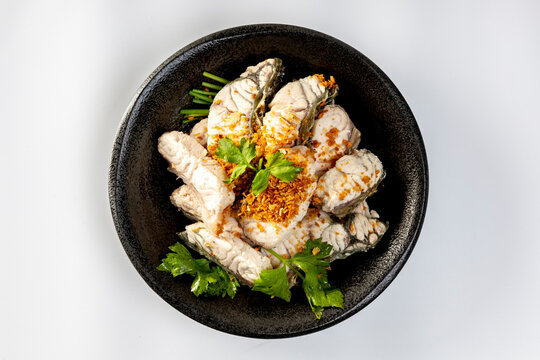 steamed sea bass sliced fish with dipping sauce and vegetable