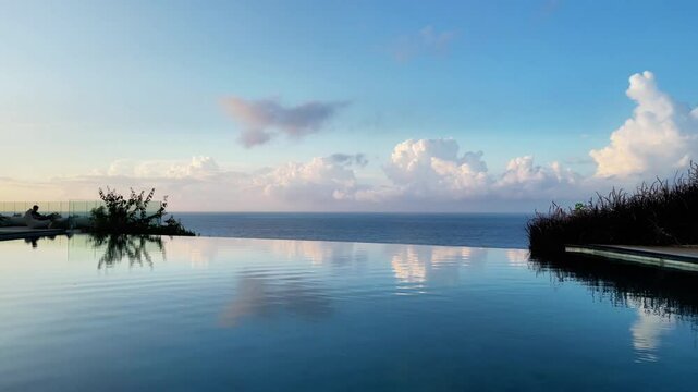 4K drone footage of a luxury infinity pool on a cliff with sweeping ocean views in Asia. Cinematic, tropical travel content showing architecture and nature in harmony.
