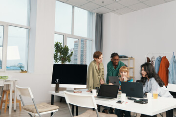 young adult coworkers working together in modern workplace, business meeting with colleagues...
