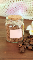 Fototapeta premium Instant Coffee Granules in Glass Jar with Coffee Beans and Flower