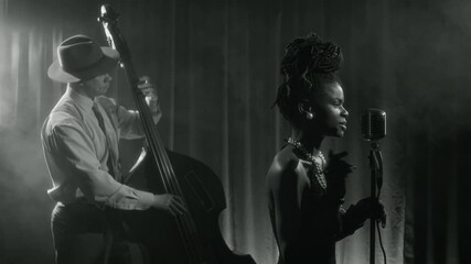 Black and white shot of glamorous Black woman singing to microphone during classic music band performance on stage in vintage club - Powered by Adobe