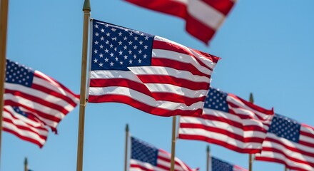 Obraz premium American flags waving in the wind against a blue sky patriotic symbol of the united states of america