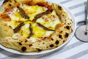 The most authentic Neapolitan pizza with anchovies, anchovies from the Mediterranean Sea, extra virgin olive oil and buffalo mozzarella cheese