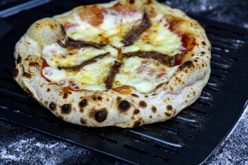 The most authentic Neapolitan pizza with anchovies, anchovies from the Mediterranean Sea, extra virgin olive oil and buffalo mozzarella cheese