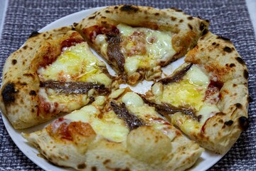 The most authentic Neapolitan pizza with anchovies, anchovies from the Mediterranean Sea, extra virgin olive oil and buffalo mozzarella cheese