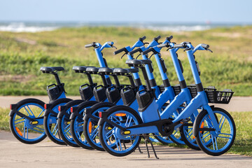 Shared Electric Bicycles Parked Outdoors.