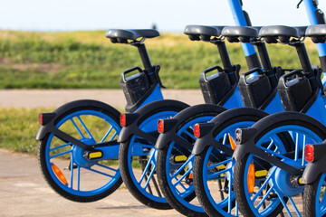 Shared Electric Bicycles Parked Outdoors.