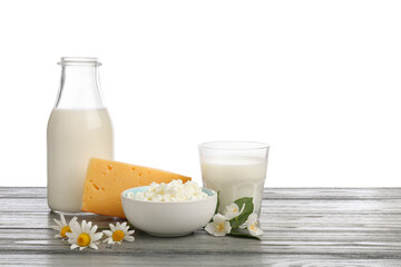 Different fresh dairy products and flowers on grey wooden table against white background