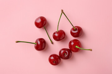 Fresh ripe cherries on pink background, flat lay