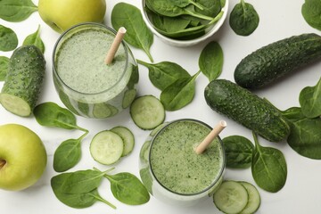 Tasty spinach smoothie and ingredients on white table, flat lay