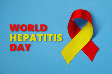 28th july World Hepatitis Day. Yellow-red awareness ribbon on light blue background, top view