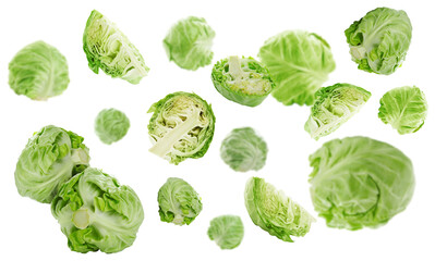 Fresh ripe cabbages falling on white background