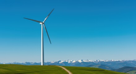 Fototapeta premium A Single Modern Wind Turbine Generating Renewable Energy in a Lush Green Landscape Under a Clear Blue Sky with Distant Snow-Capped Mountains