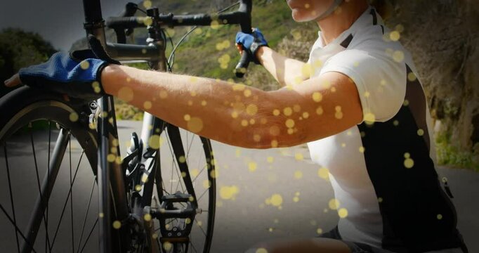 Female cyclist stopping bike on mountain road and adjusting front wheel alignment for health safety