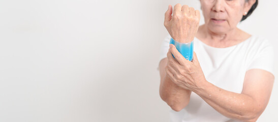 Elderly Woman having wrist pain and Edema with Cold Gel pack for Carpal Tunnel Syndrome, Wrist...