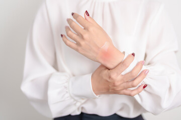 Woman having wrist pain with Medicated pain relief patch plaster for Carpal Tunnel Syndrome, Wrist...