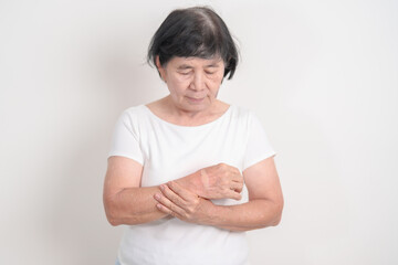 Elderly Woman having wrist pain with Medicated pain relief patch plaster for Carpal Tunnel...
