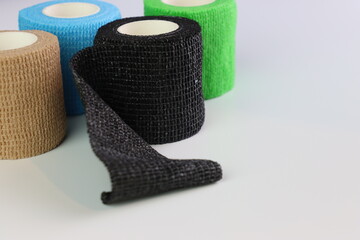 Different colors of cohesive bandages. Non adhesive bandage in a white background with different colors