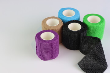 Different colors of cohesive bandages. Non adhesive bandage in a white background with different colors