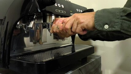 A black espresso machine with a silver top - Powered by Adobe