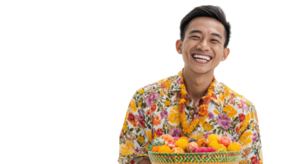 Happy man holding a basket of colorful fruits, floral shirt, cheerful expression, white isolated background.
