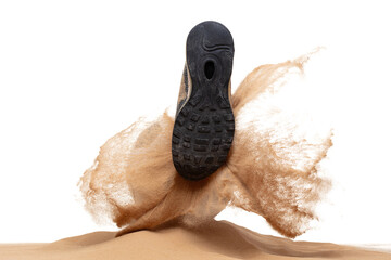 Shoe shooting Classic sport football ball on sand pile over white background isolated. Sand...