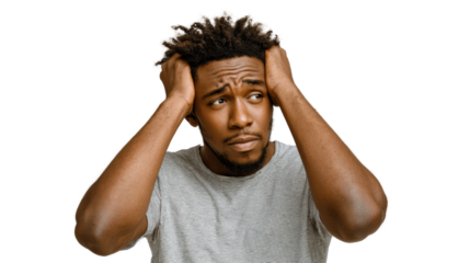 Young man in distress holding his head, expressing frustration and confusion.