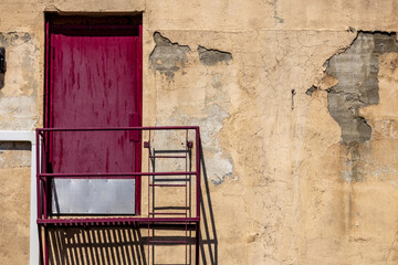 Red door and peeling paint