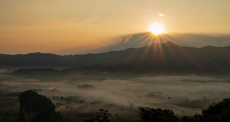 Sunset mountain range beautiful landscape mist foggy sunrise beam. Golden sky Mountain landscape...