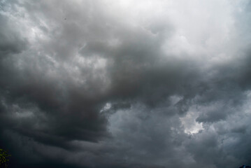Dramatic dark storm thundercloud rain clouds on black sky background. Dark thunderstorm clouds...