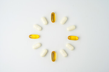 Clock made of pills capsules, pills form a circle, omega, vitamins, Cod liver oil, supplements