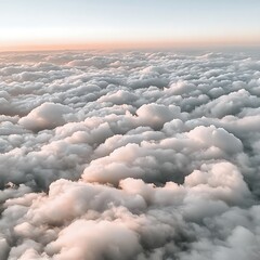 Aerial view of ethereal cloudscape showcasing fluffy formations during tranquil dawn
