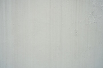 A light, off-white wall with subtle vertical streaks and a slightly weathered texture. Ideal as a...