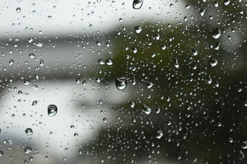 water drop on mirror in rainy day, blur natural background