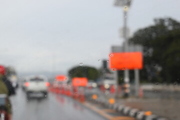 car on highway road with rainny season, blurred image