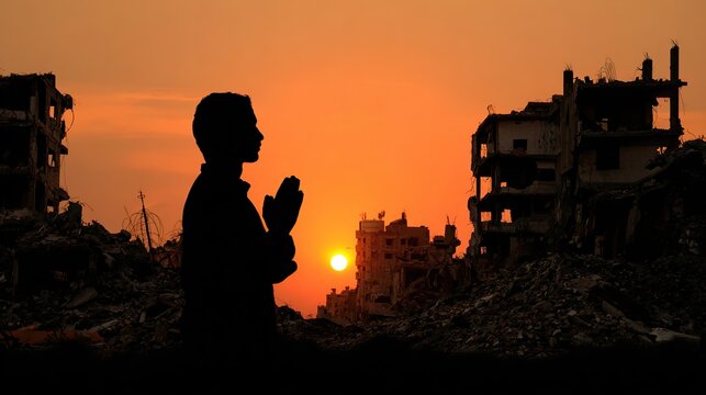 Silhouette of a person praying amidst war-torn ruins at sunset - Powered by Adobe