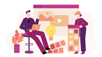 Two designers sit at a desk, collaborating on a website project. Ideal for website design, graphic design, teamwork, technology concepts.