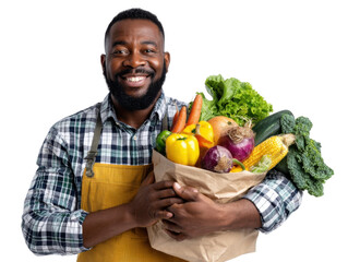 Fototapeta premium Smiling Man Holding a Bag of Fresh Vegetables: A happy, dark-skinned man smiles warmly while holding a paper bag overflowing with a variety of fresh, colorful vegetables.