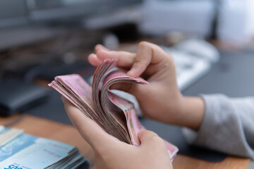 Close-up photograph of hands counting cash banknotes a business concept for financial articles and...