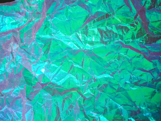 Holographic Abstract soft pastel colors backdrop. Hologram Crumpled Foil Aesthetic. Background for banner, backdrop or texture. Trendy creative gradient.