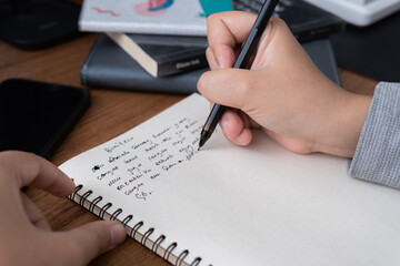 Authentic lifestyle photograph of a person writing, photographic style, ideal for business blogs,...