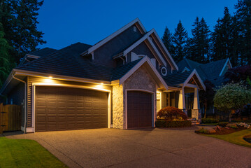 Garage door in luxury house with trees and nice landscape in Spring in Vancouver, Canada, North...