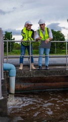 Wastewater treatment plant engineers are working together to inspect the wastewater treatment system for defects in order to improve the system.