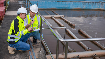 Wastewater treatment plant engineers are planning and discussing the installation of a new filtration system for a wastewater treatment plant.