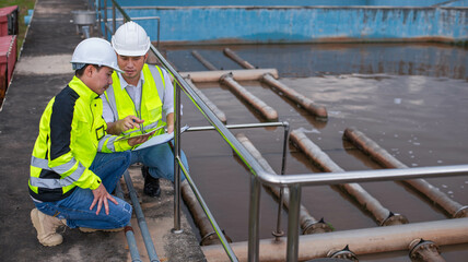 Wastewater treatment plant engineers are planning and discussing the installation of a new filtration system for a wastewater treatment plant.